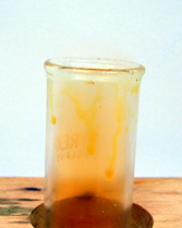 Orange bromine produced by the reaction between potassium bromide and concentrated sulphuric acid