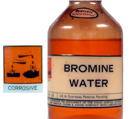 A bottle of bromine water showing corrosive hazard