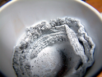 Magnesium after combustion. The colour suggests that it is not pure (white) magnesium oxide