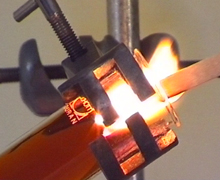 Thermal decomposition of magnesium nitrate readily produces a brown gas and oxygen which relights a glowing splint