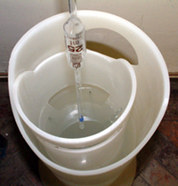 A pipette being placed, tip upwards, into a pipette washer