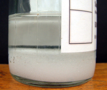 A saturated solution with undissolved solid at the bottome of the bottle