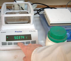 A beaker is tared on a top pan balance