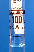 A rolled up piece of filter paper is used to dry the flask above the line