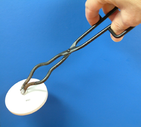 A pair of tongs used to lift a crucible lid