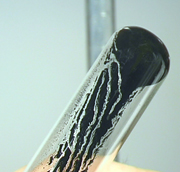 Solid remains in the glassware if it is poured off too slowly