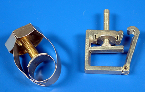 Two designs of tubing clips. The one on the right will control flow rate by squeezing the tubing